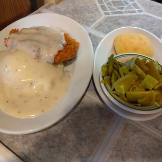 Country Fried Steak with Mashed Potatoes & Gravy, Green Beans and a Roll. (Our Most Popular Special)